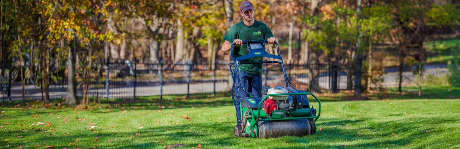 lawn technician aerating lawn