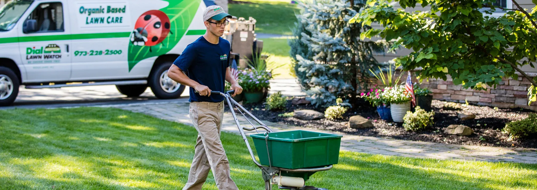 Dial Environmental tech fertilizing lawn