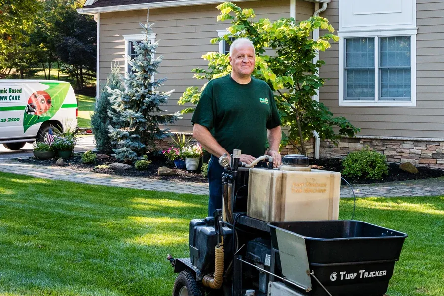 lawn technician fertilizing lawn